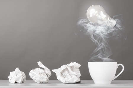 creative process  crumpled wads and cup on grayの写真素材