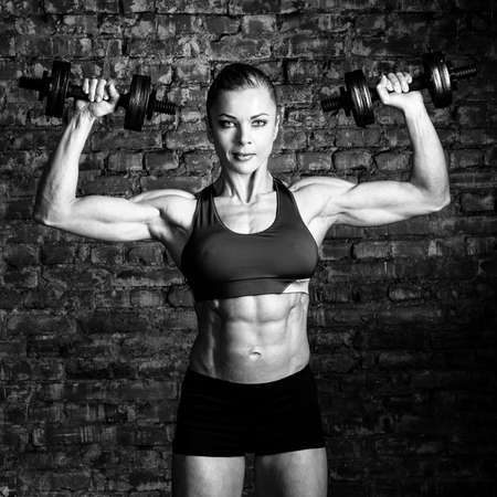 strong woman is training with barbellsの写真素材