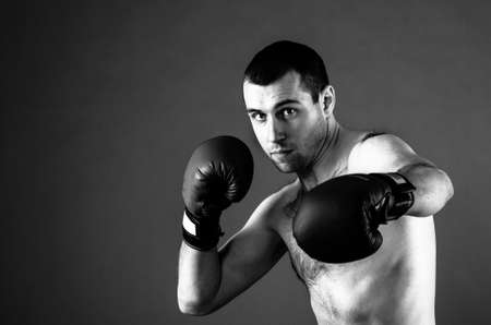 portrait of mma fighter in boxing pose on gray backgroundの写真素材