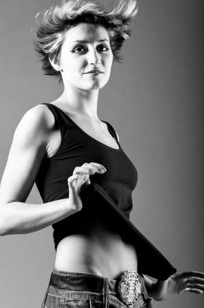 dancing woman wearing black tank top and jeansの写真素材