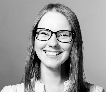 happy beautiful young caucasian woman on gray backgroundの写真素材