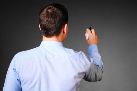 caucasian businessman is writing in airの写真素材