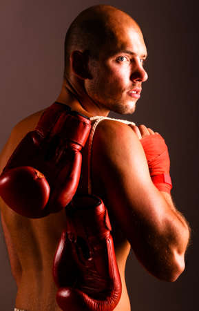 confident fighter is looking back on dark backgroundの写真素材