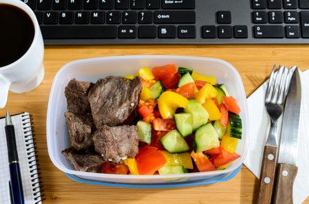 homemade lunch box at modern stylish work place, view from above