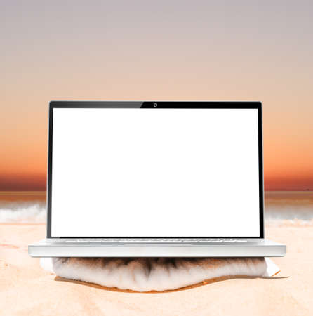 laptop on beach at sunrise ready for remote work or freelanceの写真素材