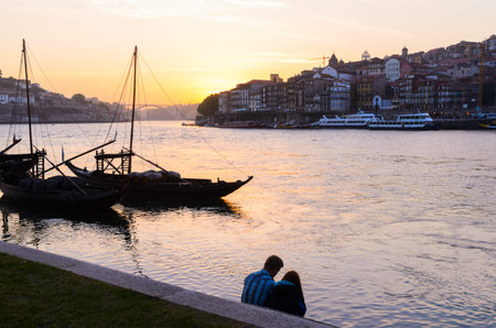 sunset view of traditional boats and Douro river in Porto, Portugalの写真素材