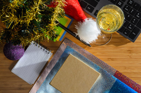 office desk with christmas accessories, wrapping paper for presents and stationery, view from above