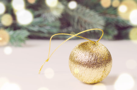 decorative christmas ball and fir tree on white surfaceの写真素材