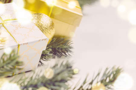 decorative christmas gift boxes and balls on white surface, view from aboveの写真素材