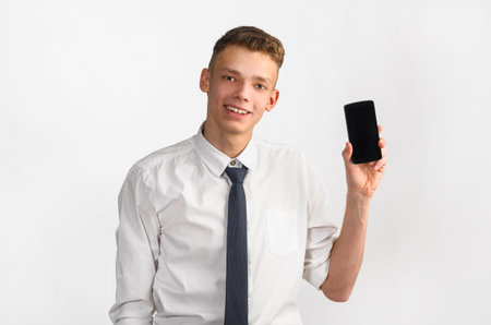 portrait of young stylish businessman on gray background