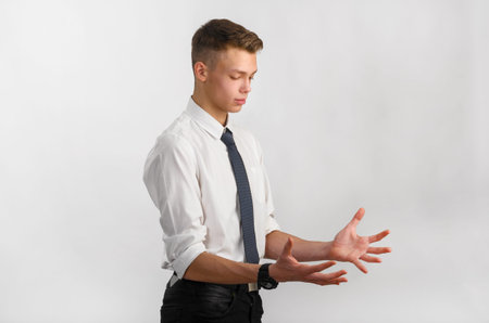 portrait of young stylish businessman on gray background