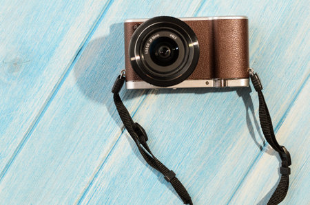 top view of retro style camera on blue wooden table