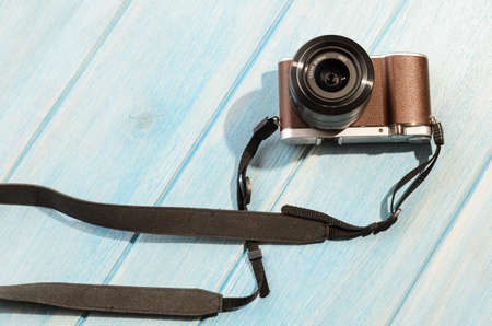 top view of retro style camera on blue wooden tableの写真素材