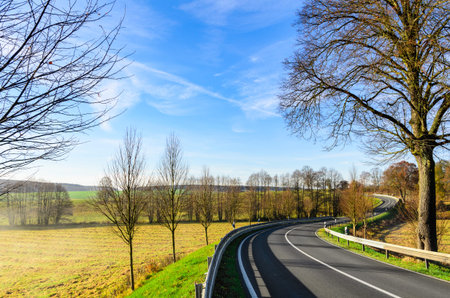 autumn road at sunny day in Germanyの写真素材