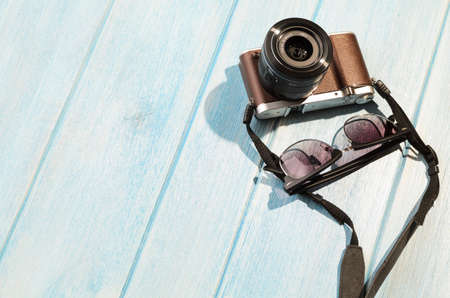 top view of retro style camera on blue wooden tableの写真素材