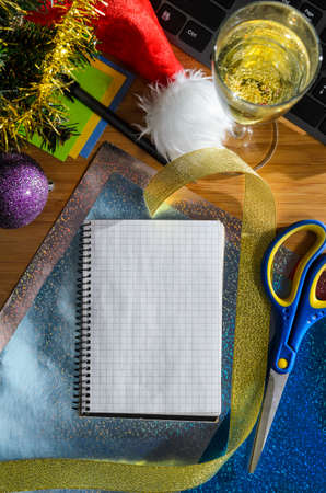 office desk with christmas accessories, wrapping paper for presents and stationery, view from aboveの写真素材