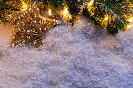 Christmas fir tree with lights and star on snow in dark, view from aboveの写真素材