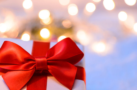 Christmas fir tree with lights and candy cane on snow in dark, view from aboveの写真素材