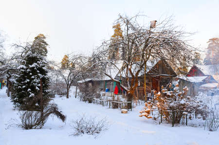 rural house covered with snow in Russian villageの写真素材
