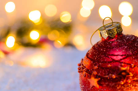 Christmas fir tree with lights and candy cane on snow in dark, view from aboveの写真素材