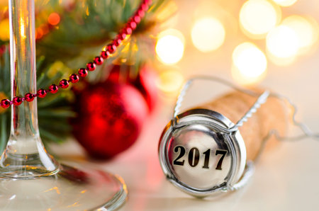 sparkling wine or champagne cork on table with christmas or new year blurred background and...