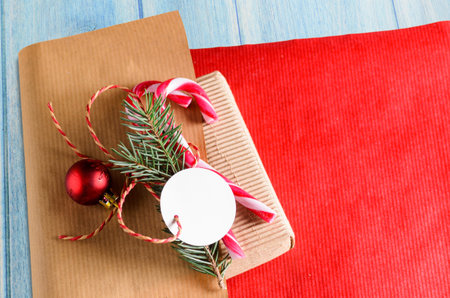 christmas or new year decoration for gift box of two candy cones with fir-tree branch and blank...