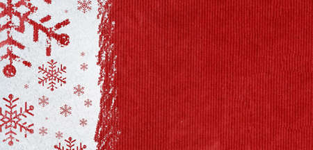 christmas card or new year background made of snowflakes symbols handwritten on snow and red craft paperの写真素材