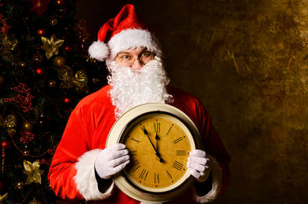 Santa Claus holding clock with countdown to Christmas or New Yearの写真素材