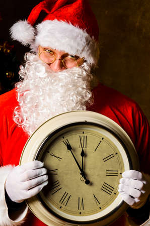Santa Claus holding clock with countdown to Christmas or New Yearの写真素材