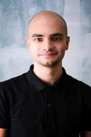 Portrait of young adult happy man agaist grunge wallの写真素材