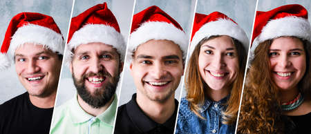 Group of people celebrating Christmas or New Year wearing Santa hatの写真素材
