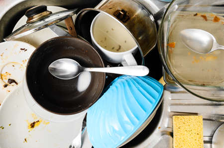 Dirty messy dishes in a sink, view from aboveの写真素材