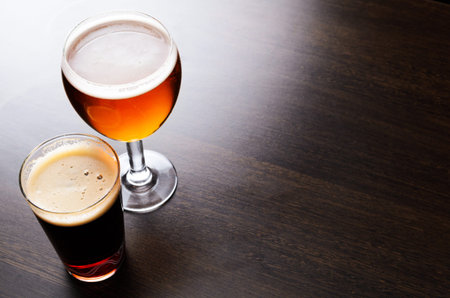 Glass of fresh beer on pub table, view from aboveの写真素材