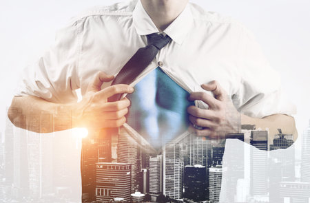Business superhero double exposure concept. Young businessman showing super hero suit under his...