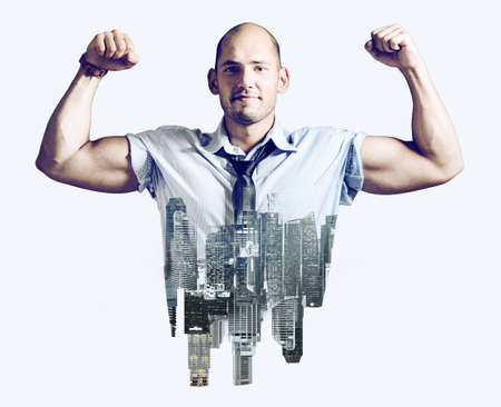 Strong businessman double exposure concept. Business man showing muscular hands, mixed with city skylineの写真素材