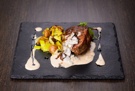 Steak with potatoes on plate, view from aboveの写真素材