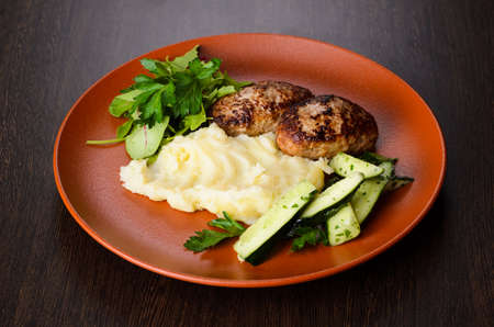 Patties with puree on plate, view from aboveの写真素材