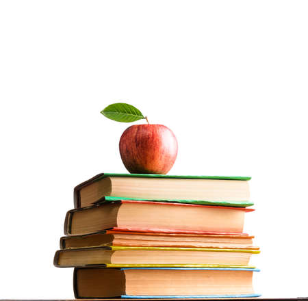 School accessories, books and fresh apple against white backgroundの写真素材