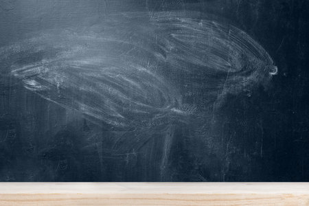 School blackboard with wooden table background