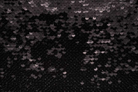 Sequin fabric background. Close-up shot of glittery black sequins textureの写真素材