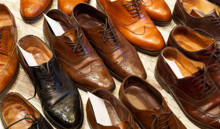 Leather shoes of different colors and types at shoe care service.の写真素材