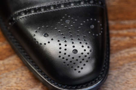 Black brogue toe of men full grain leather shoe, close upの写真素材