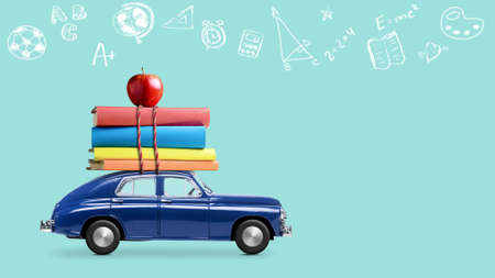 Back to school. Car delivering books and apple against school blackboard with education symbols.の写真素材