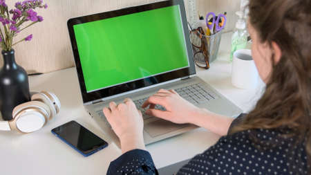 Woman working on laptop from home due to coronavirus self isolation. Authentic home workplace. Coronavirus outbreak 2020.の写真素材
