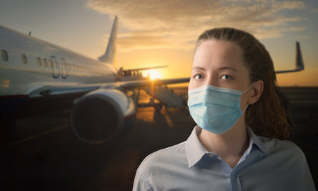 Face mask on board. Woman wearing medical mask while boarding airplane at airport. Passengers...