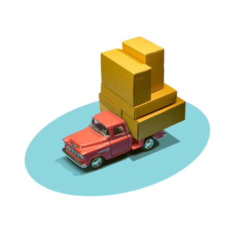 Fast order delivery by car concept. Pickup truck delivering blank boxes. Loaded retro toy car loaded with cardboard packages isolated on white background.の写真素材