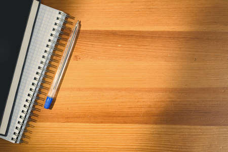 Back to school. Top view of school desk with supplies and accessories. Shadow and sun beam overlay.の写真素材