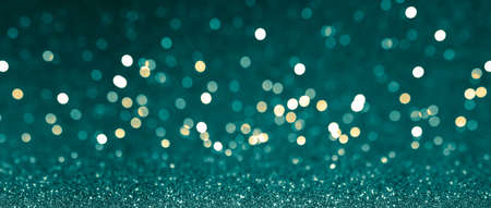 Abstract blurred background, yellow lights on blue background. Golden christmas or new year bokeh.の写真素材