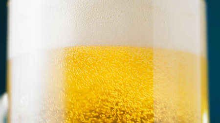 Glass of frothy fresh beerの写真素材