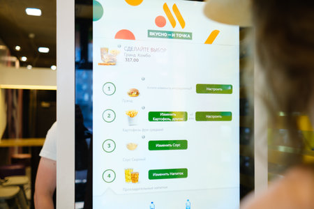 woman ordering food at fast food restaurant Vkusno I Tochkaのeditorial素材